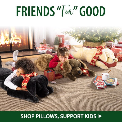 Image of two children snuggling large stuffed animal hugs. Friends Fur GOOD! Shop Pillows, Save Animals