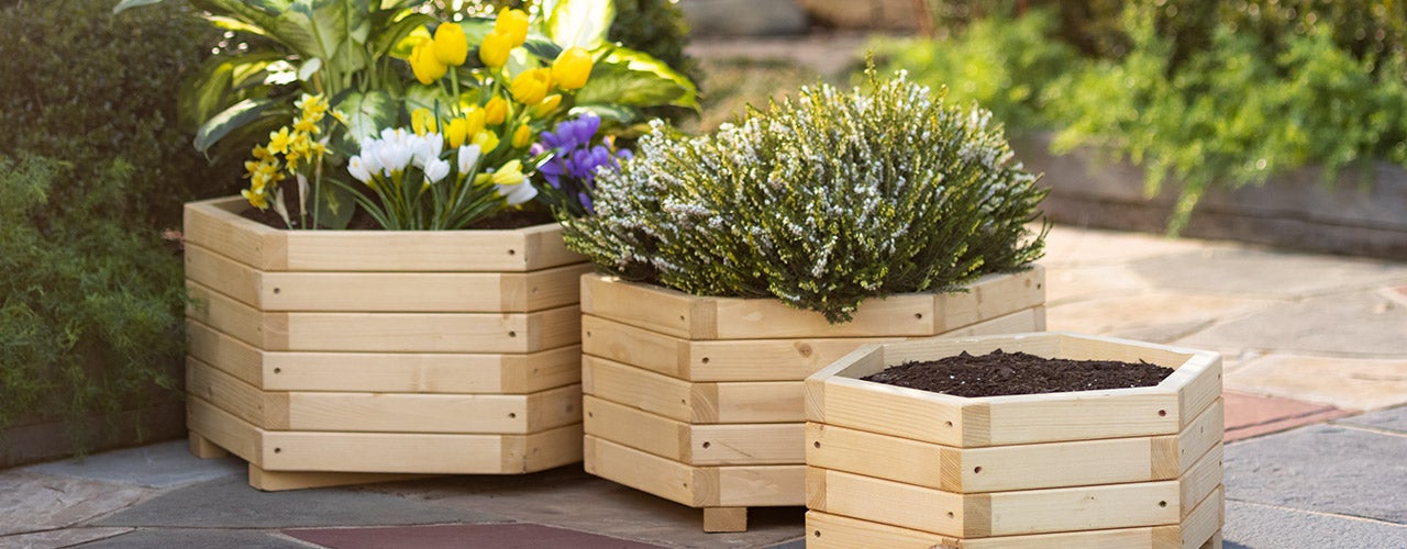 Raised Wooden Nesting Hexagon Planters filled with spring flowers