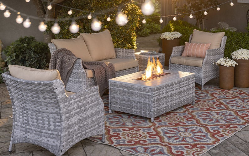 St. Helena Wicker Patio and Fire Pit Seating Set at night