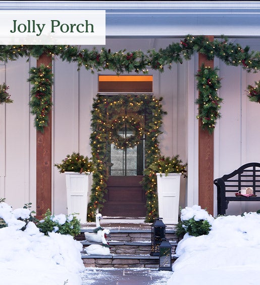 Image of assorted evergreen greenery list up on porch. Jolly Porch