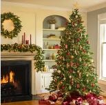 Image of a living room decorated with a lighted Christmas tree, wreath and garland