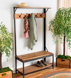 A rustic wood Deep Creek hall tree with storage crates, a bench and coat hooks.