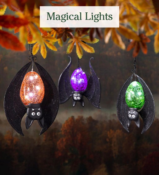 Image of Solar Halloween Hanging Bats hanging from tree. Magical Lights