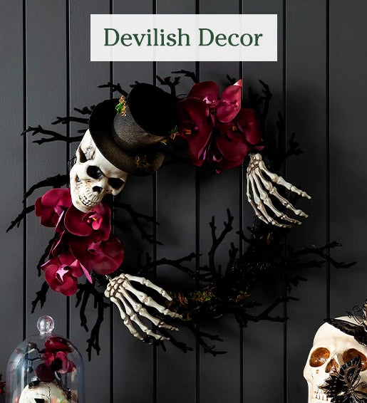 Image of Skeleton Wreath with Orchids on wall. Devilish Decor