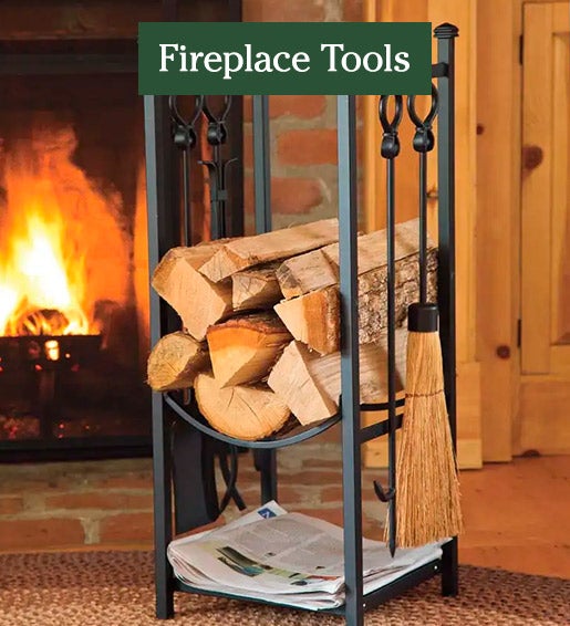 Image of Wood Rack With Fireplace Tools in front of fireplace. FIREPLACE TOOLS