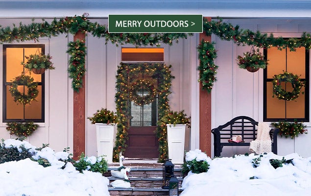 Image of Evergreen garlands on porch. MERRY OUTDOORS