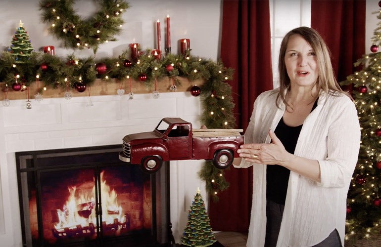 woman with christmas decorated fireplace