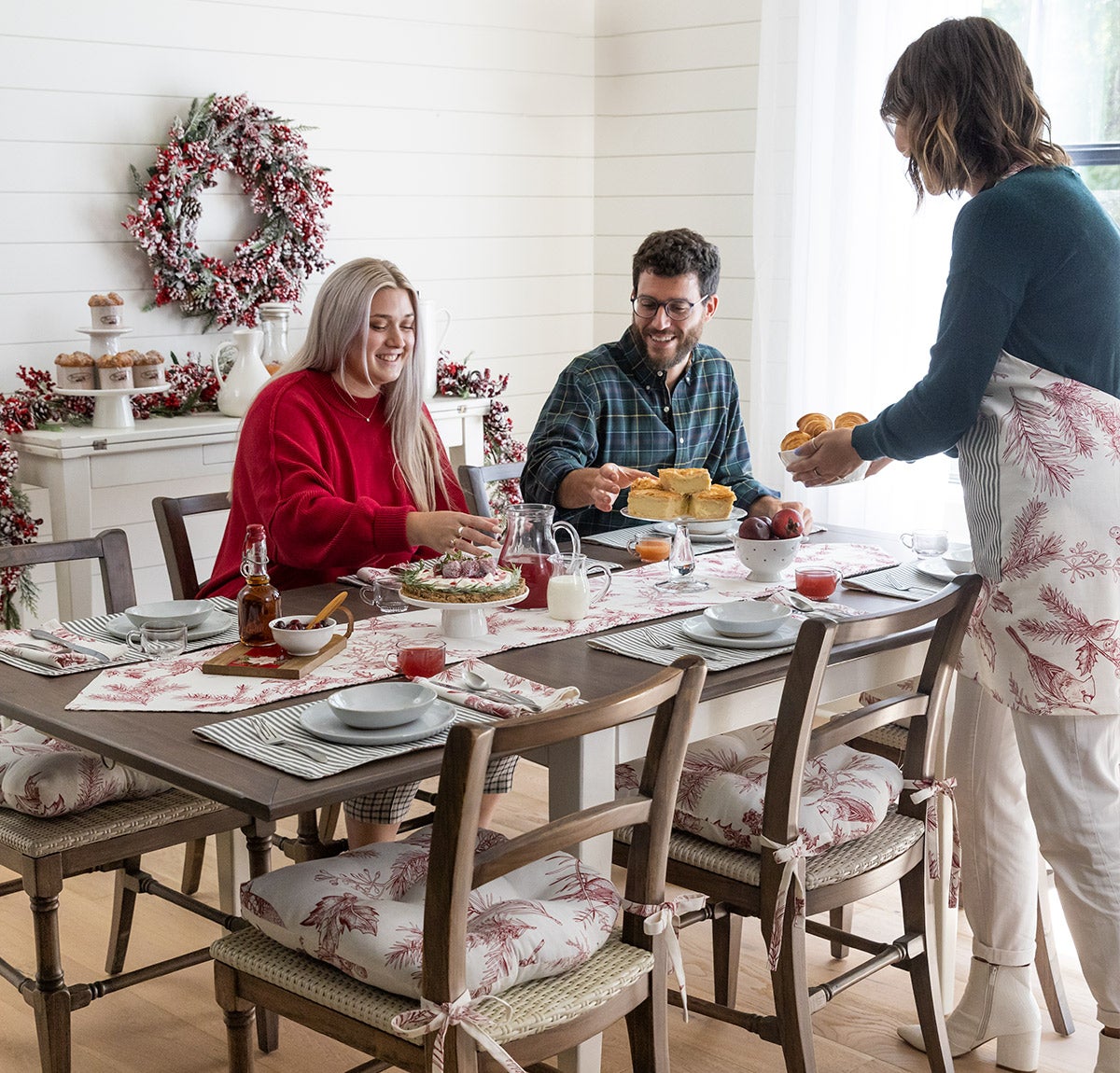 people sitting and eating a christmas meal at dining table