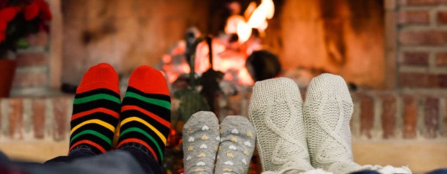 feet with socks on in front of a fire