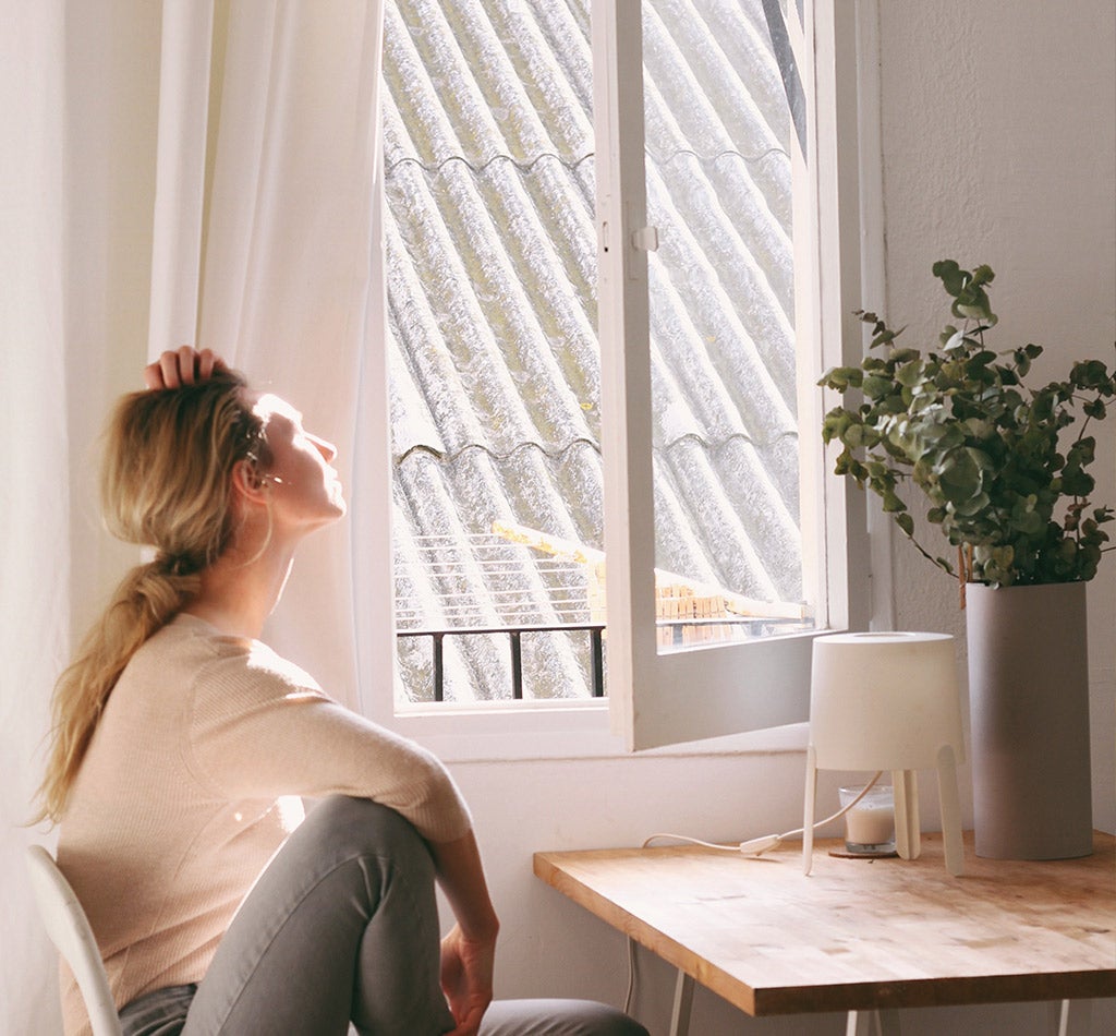 woman sitting next to open window