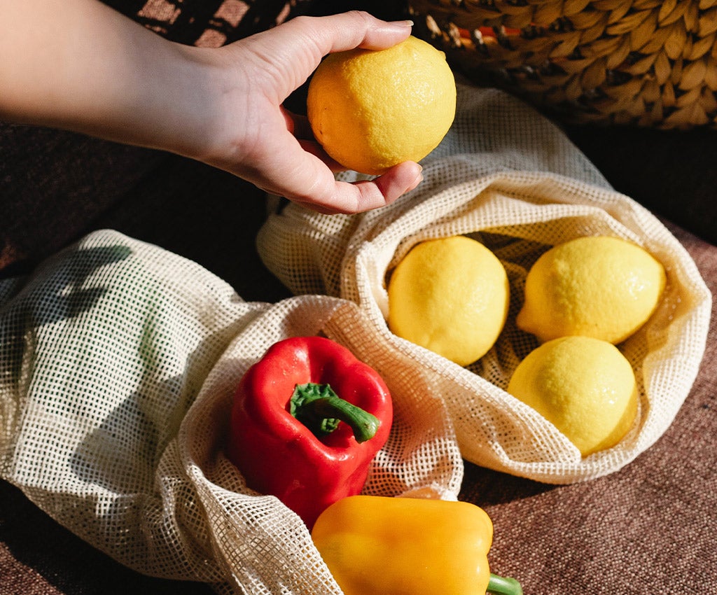 produce in reusable grocery bags