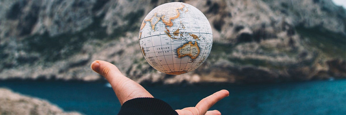 hand holding small globe