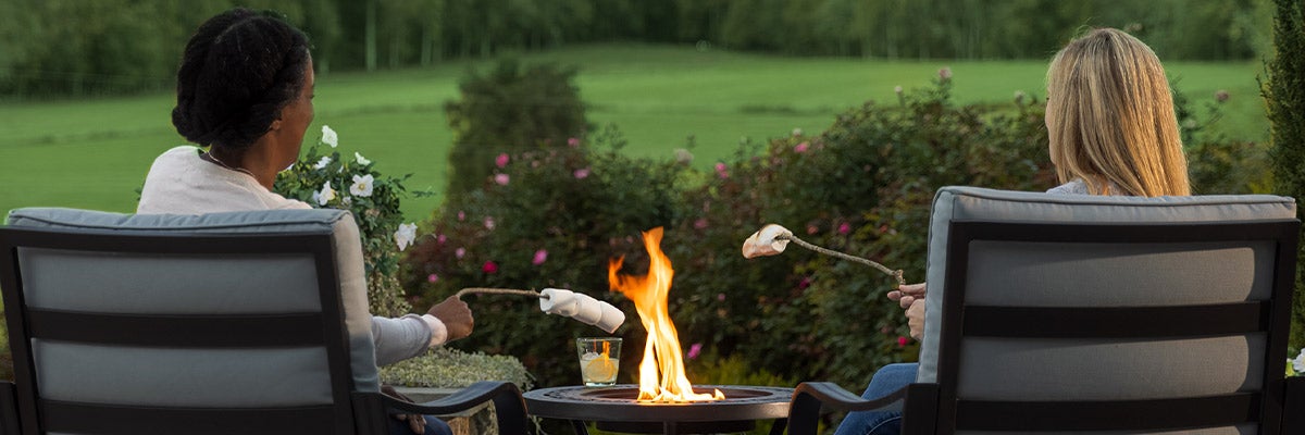 people roasting marshmallows with fire pit