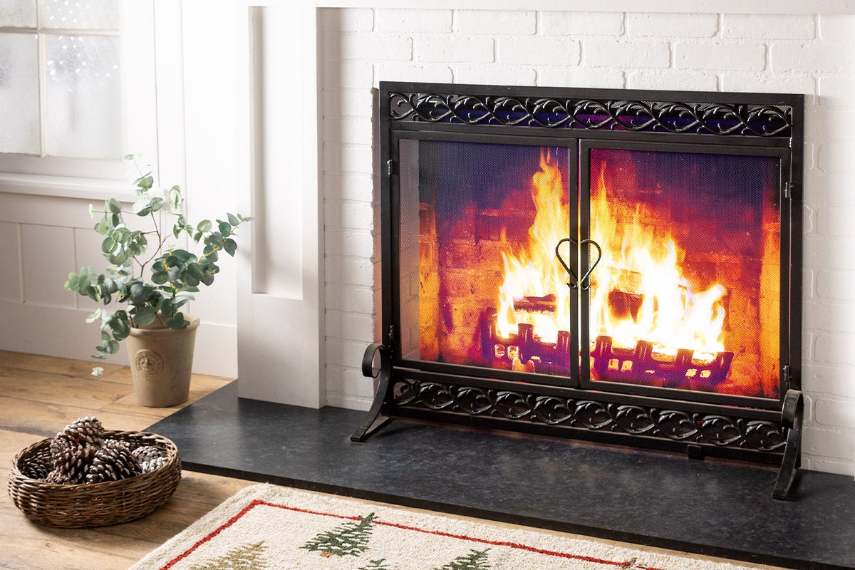 white brick fireplace with black screen