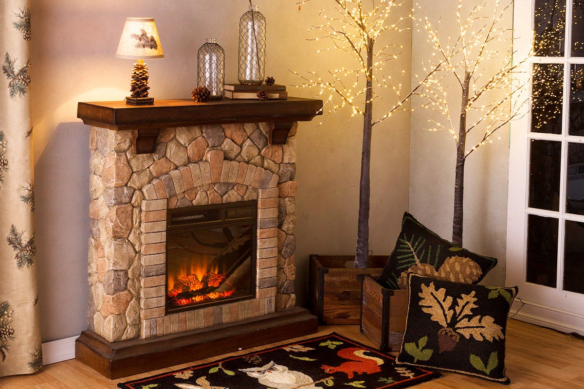stone fireplace with animal patterned rugs and pillows