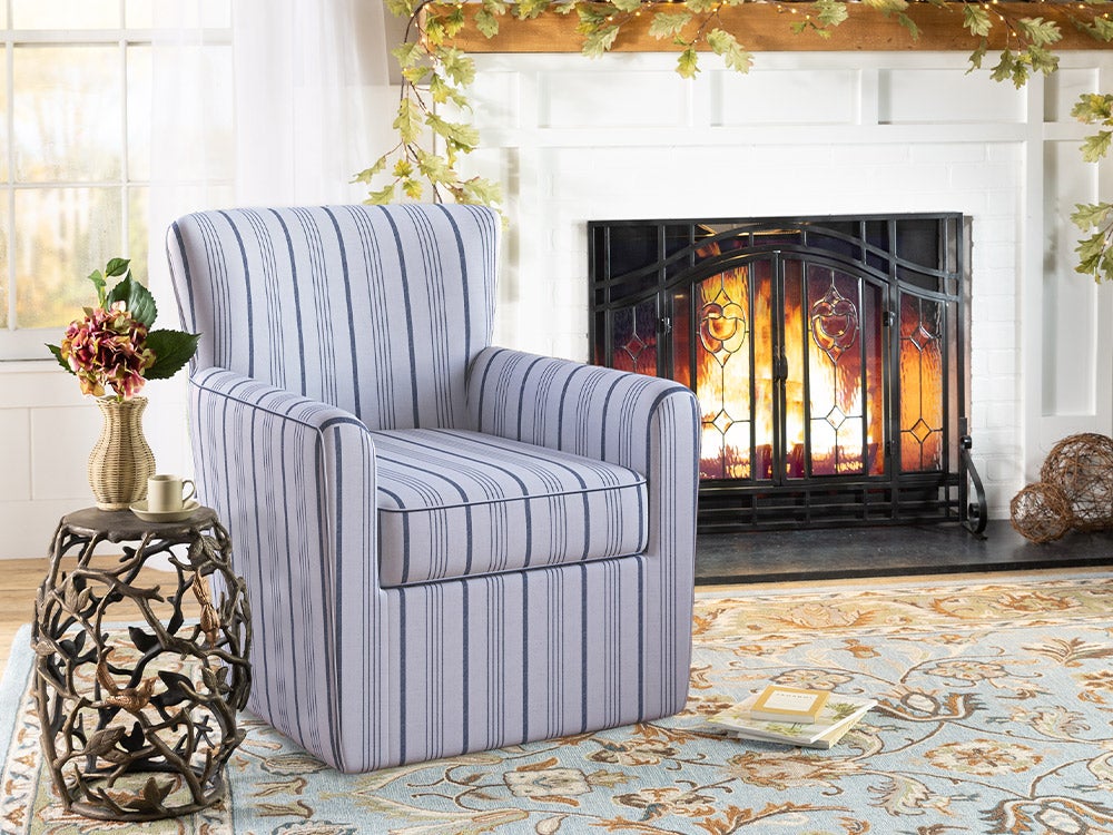 blue striped chair against white brick fireplace