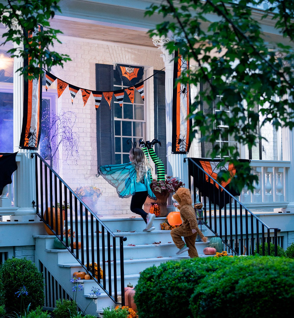 kids trick or treating on decorated front porch