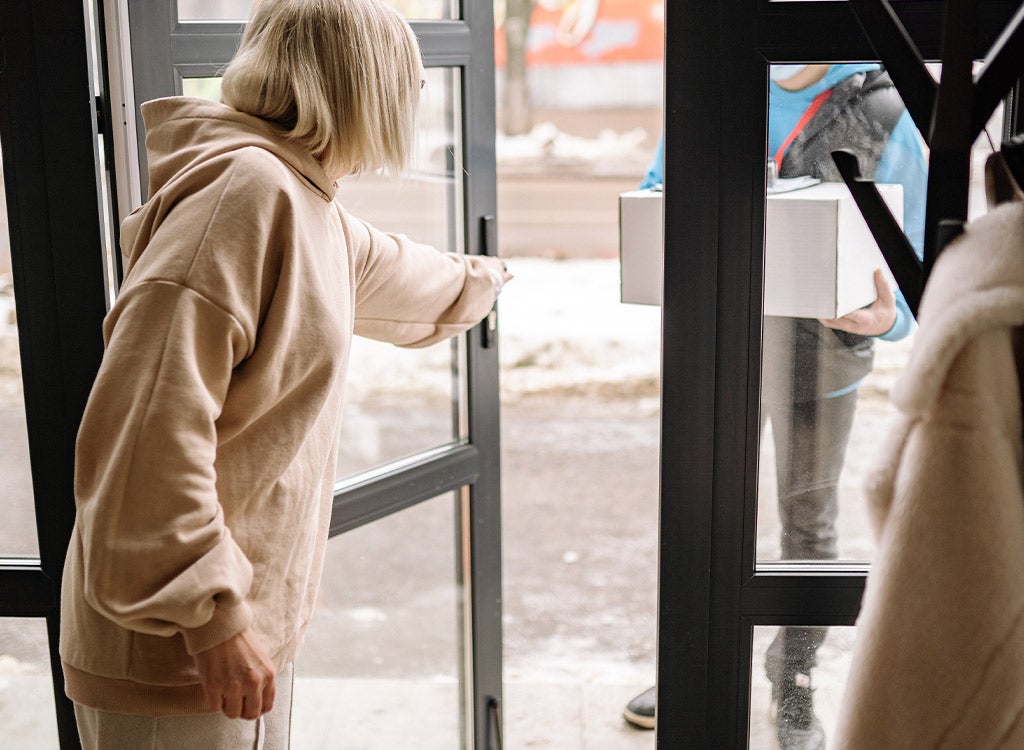 woman holding door open for man