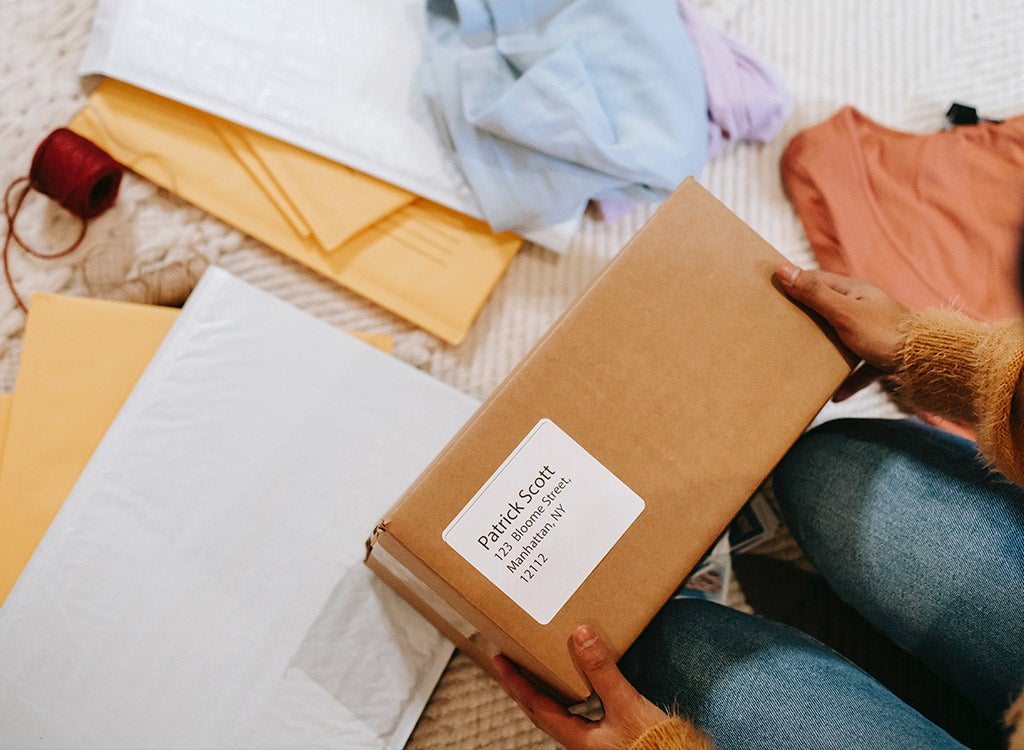 woman holding package with shipping supplies