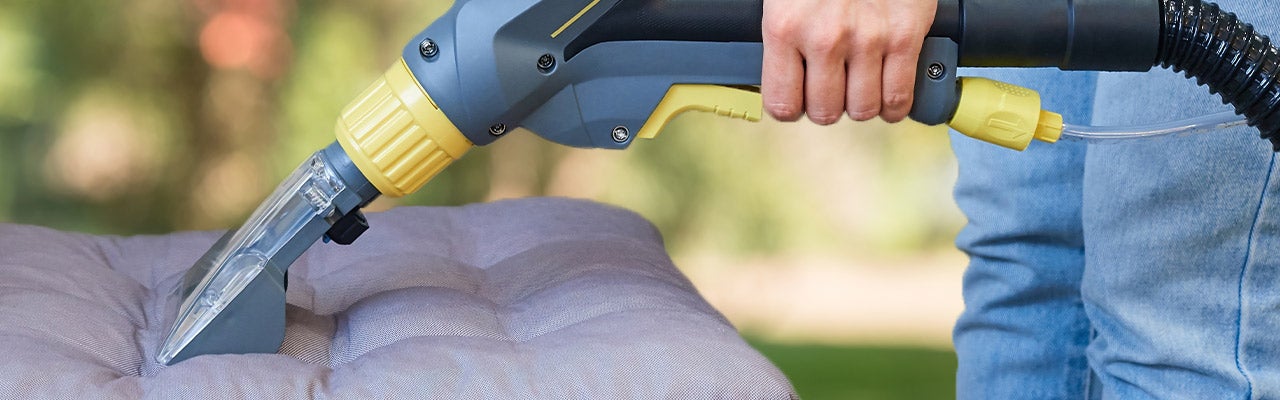 person cleaning outdoor cushions