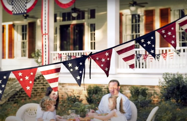 family outside with american bunting