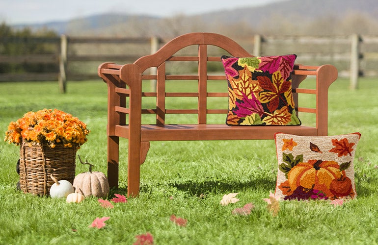 outdoor bench with fall pillow