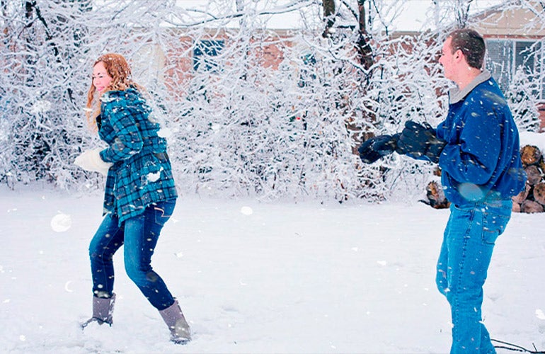 couple having snowball fight
