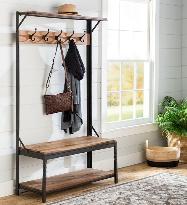 A rustic wood Deep Creek hall tree with storage crates, a bench and coat hooks.