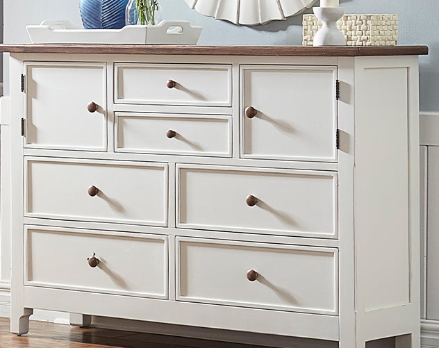 A Laurel Ridge wood farmhouse style bedroom chest in an off-white finish.